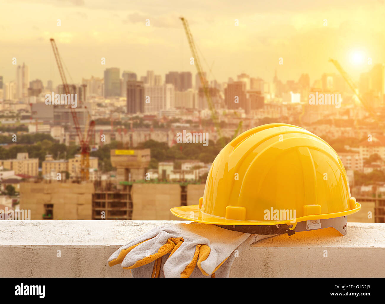Yellow hard hat on construction site Stock Photo Alamy
