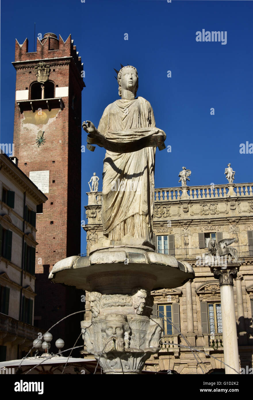 Madonna Verona fountain, the city symbol, with Gardello Tower, Palazzo Maffei and Saint Mark's Lion in the background, in Piazza Stock Photo