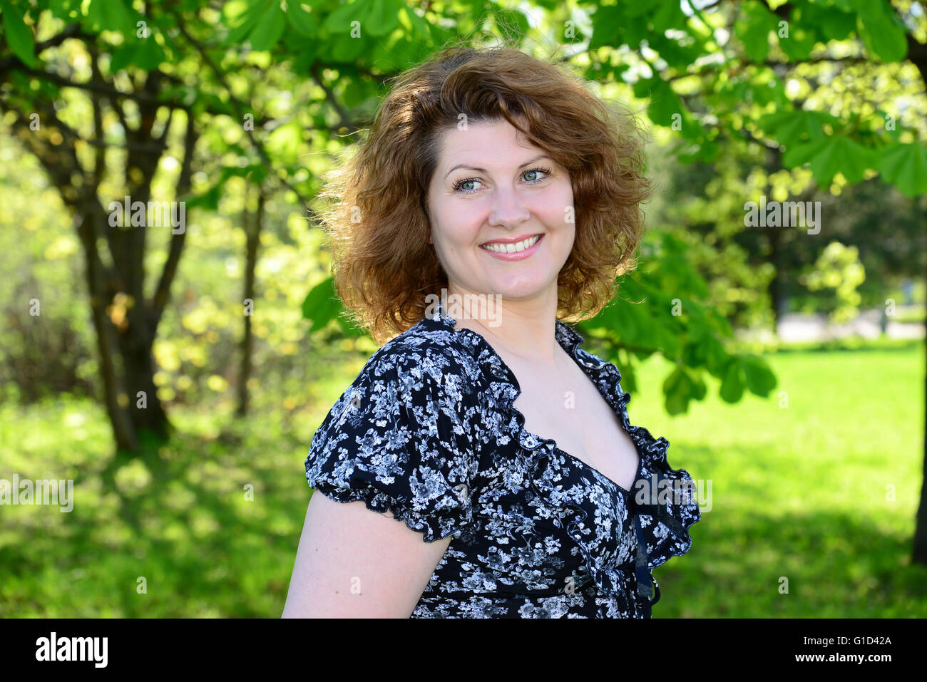 Portrait of beautiful cheerful woman in the summer park Stock Photo - Alamy
