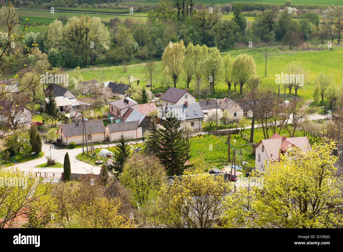Village landscape view from Janowiec Castle hillside, aerial calming rural scenery and active leisure on May day picnic, Poland. Stock Photo