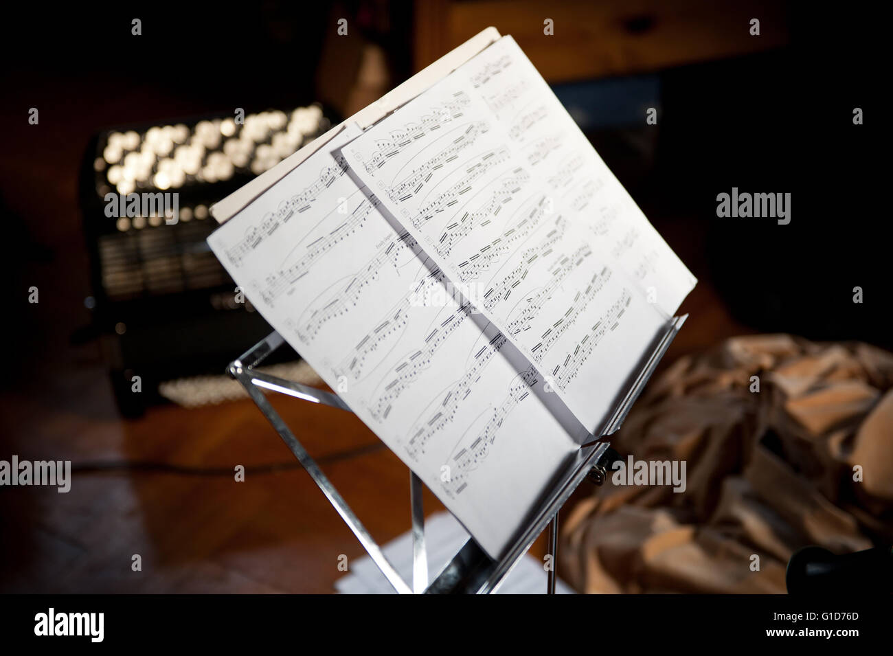 Sheet music notes in holder, metal rack with pages standing in house
