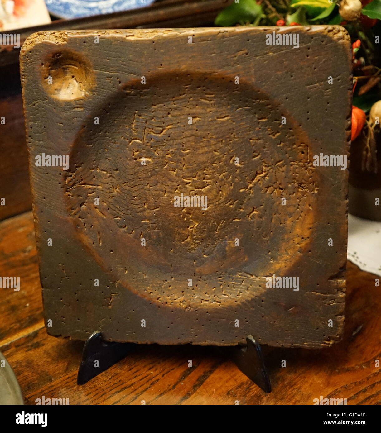 Elizabethan period wooden plate with recess for salt or seasoning