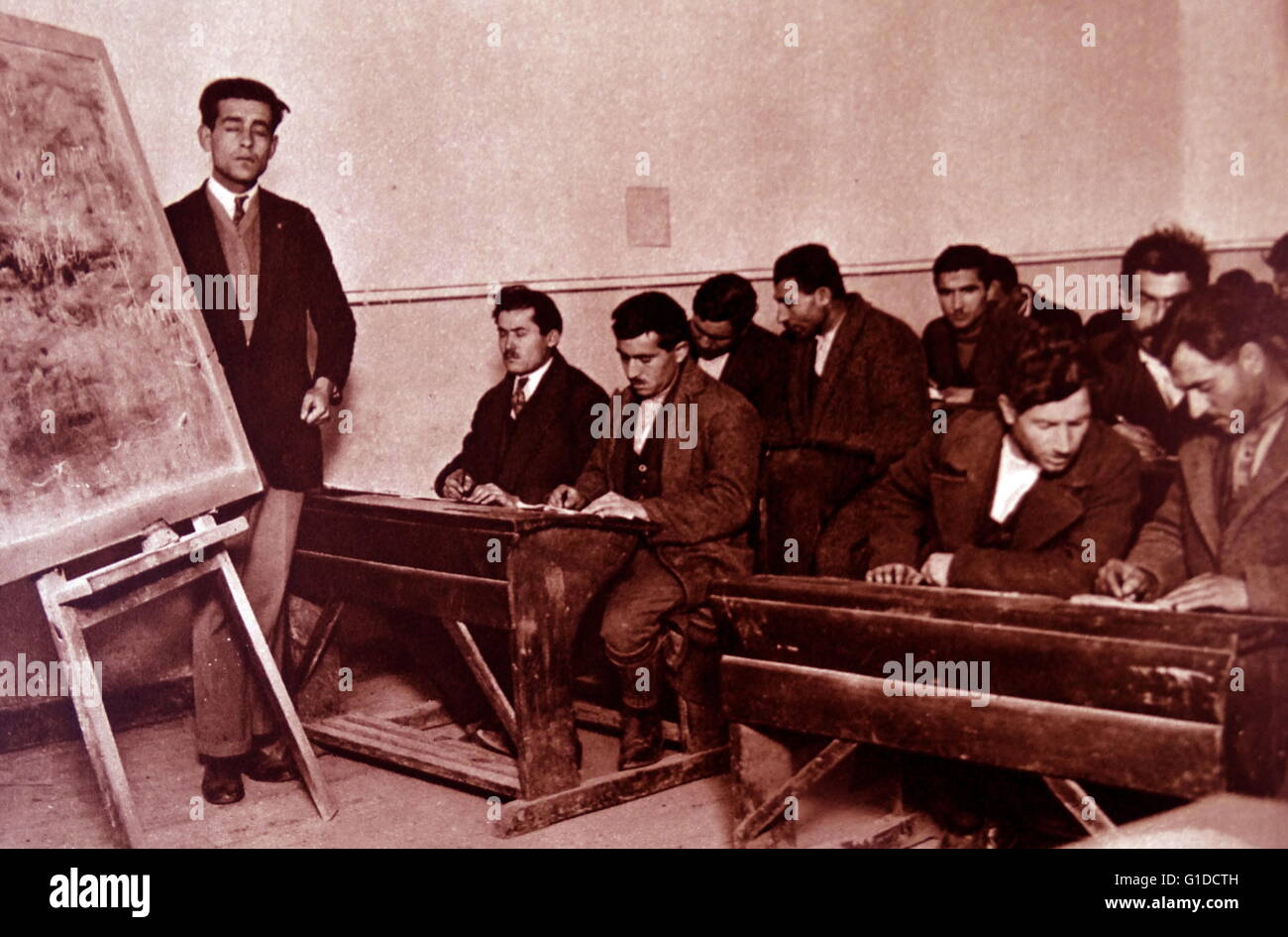 Photographic print of students being taught literacy in Turkey, under the Liberal Programmes introduced by Mustafa Kemal Atatürk (1881-1938). Dated 20th Century Stock Photo