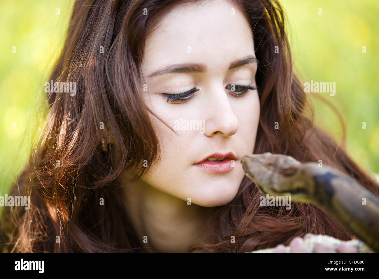 Attractive teenage girl holding the python close near the face Stock ...
