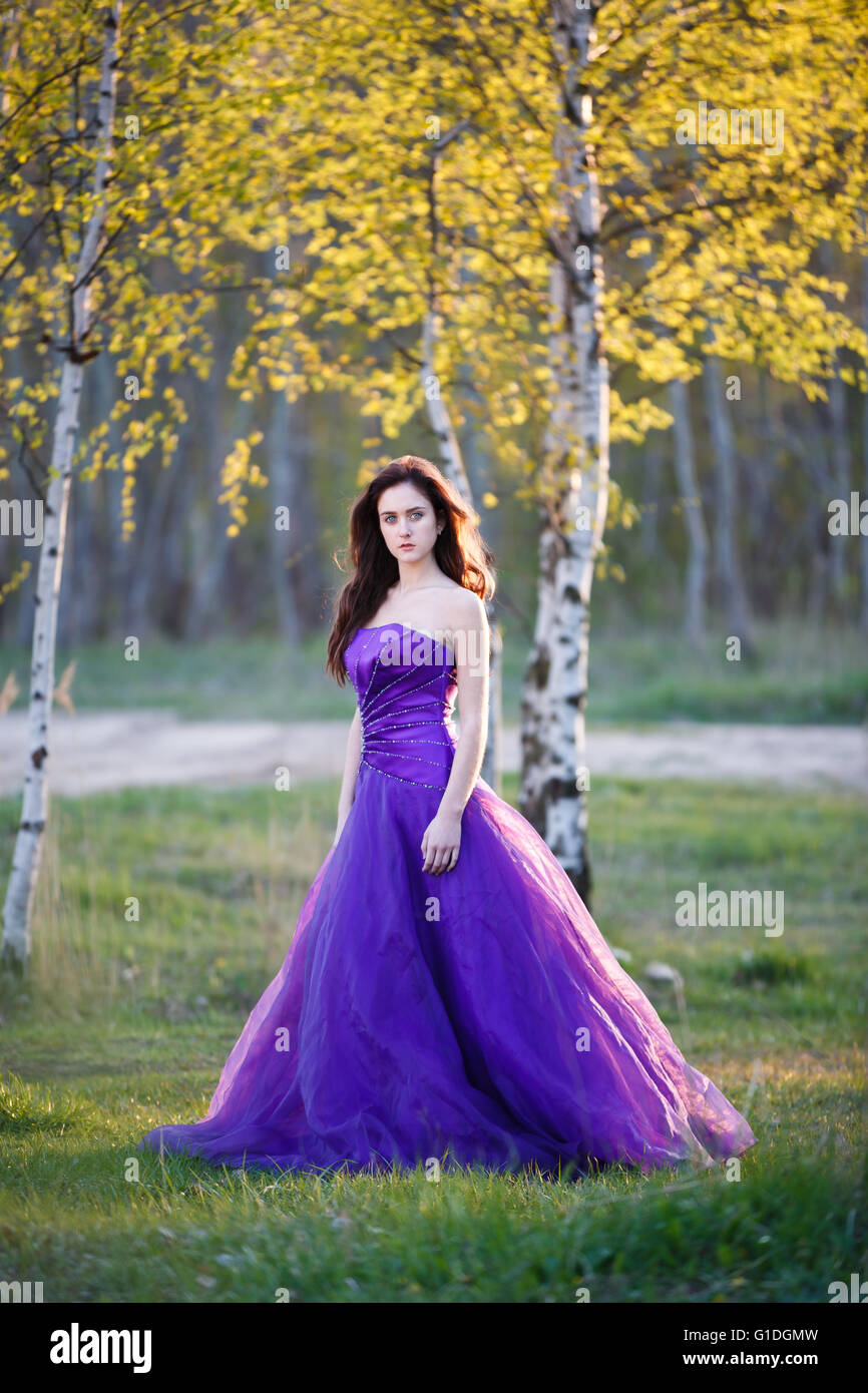 Attractive girl dressed evening gown under the birch Stock Photo