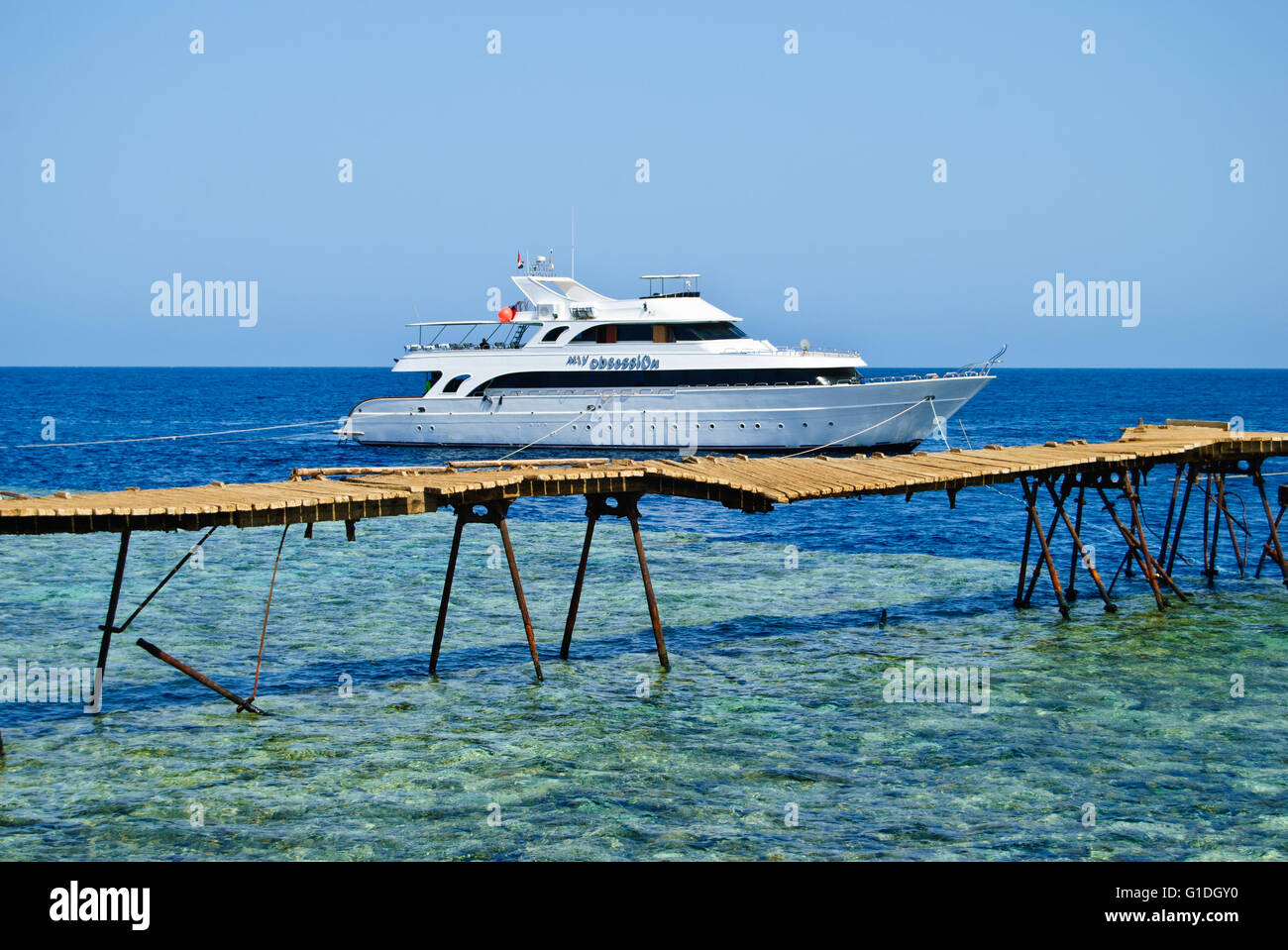 Old walking bridge from the lighthouse to the deep water at the Big Brother atoll, Red Sea. Stock Photo