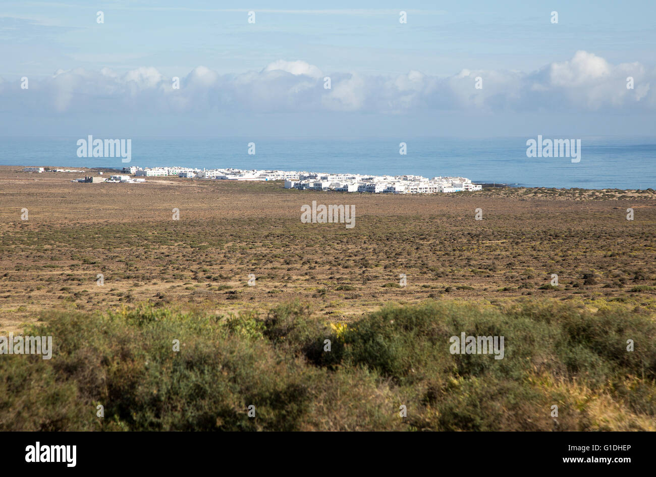 White cuboid buildings of coastal village La Caleta de Famara, Lanzarote, Canary islands, Spain Stock Photo