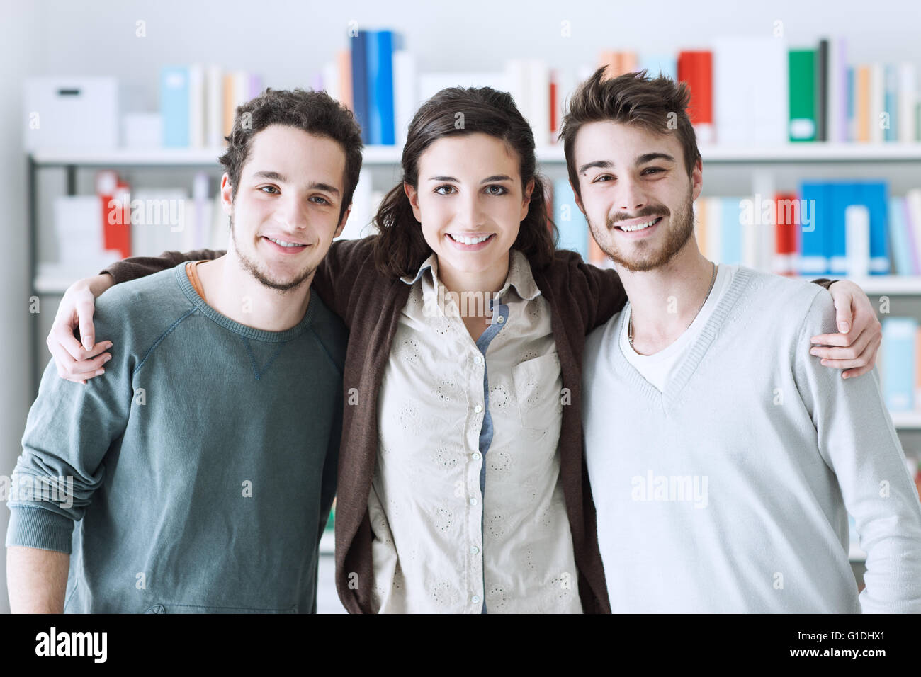 Teenager friends at the library posing together and hugging, youth and friendship concept Stock Photo