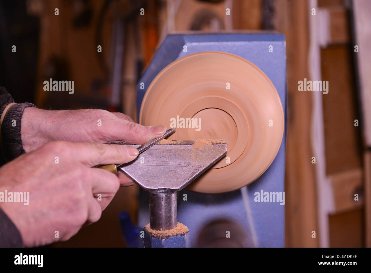 Woodturners using a rotating clamp to turn the wood, France Stock Photo Alamy
