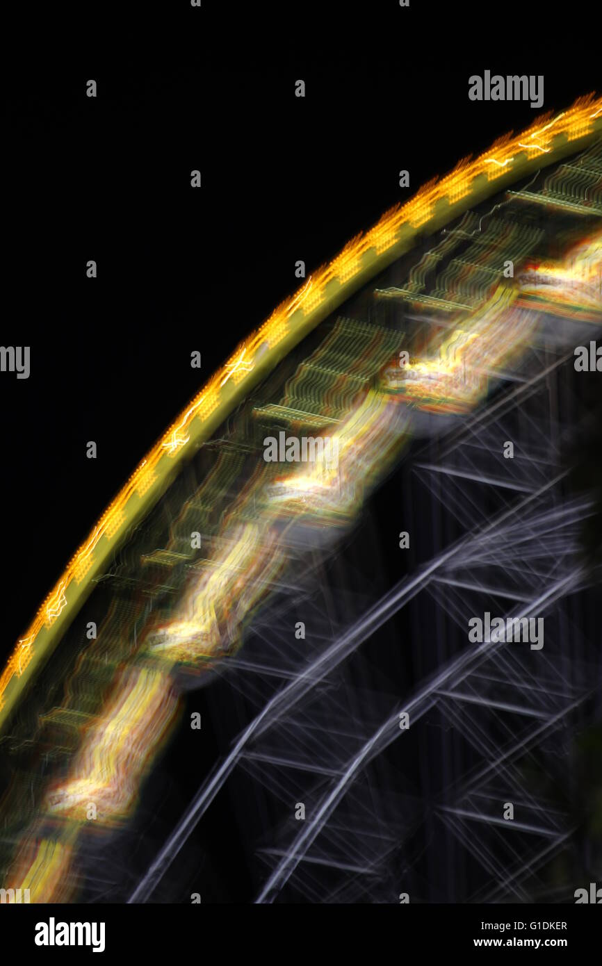 Ferris wheel in the night with motion blur Stock Photo - Alamy