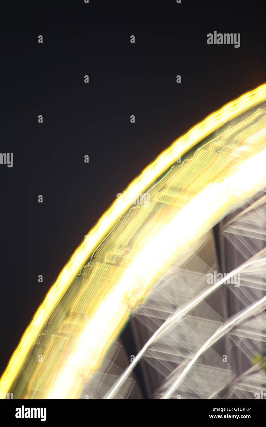 Ferris wheel in the night with motion blur Stock Photo - Alamy