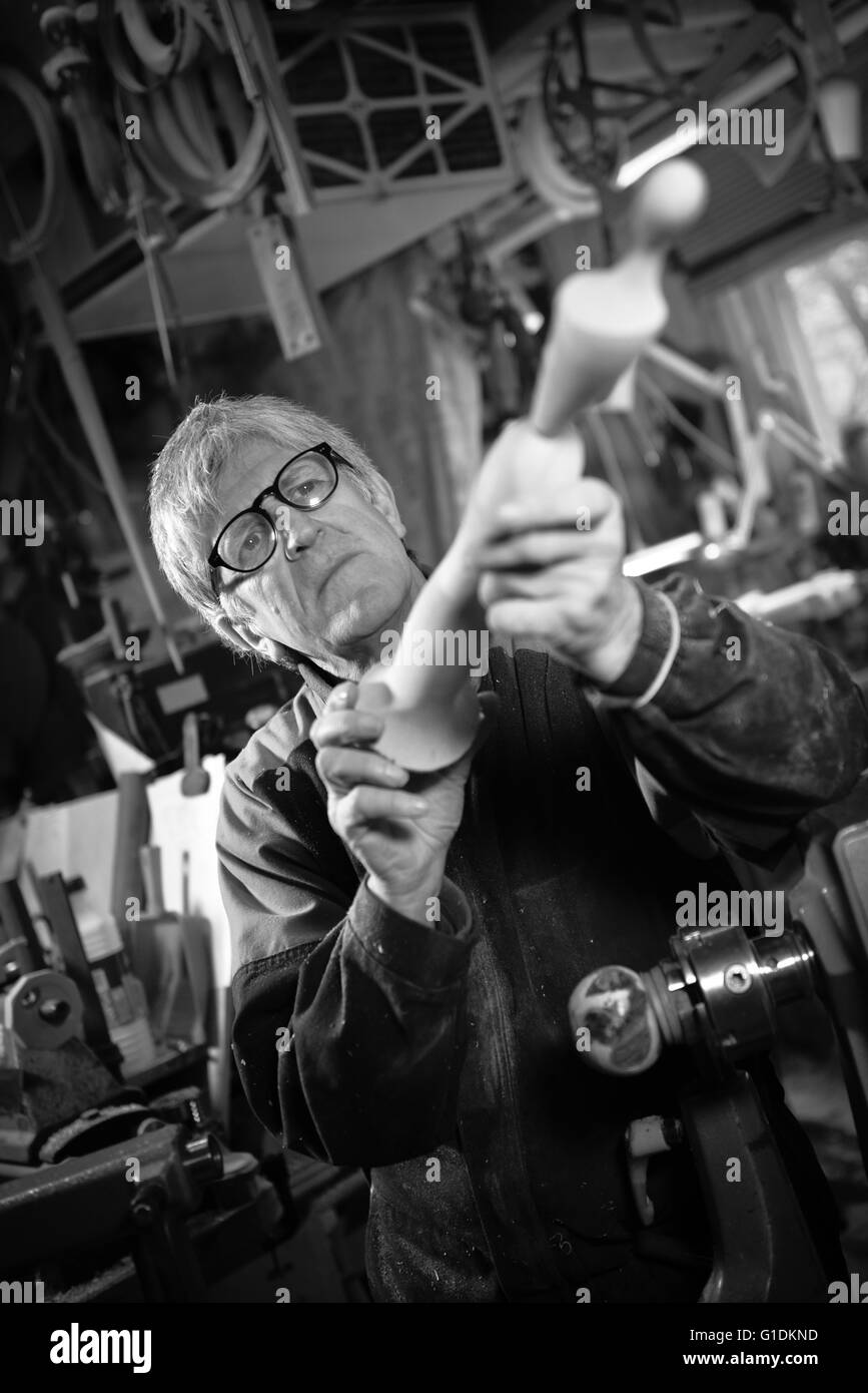 Woodturners using a rotating clamp to turn the wood, France Stock Photo Alamy