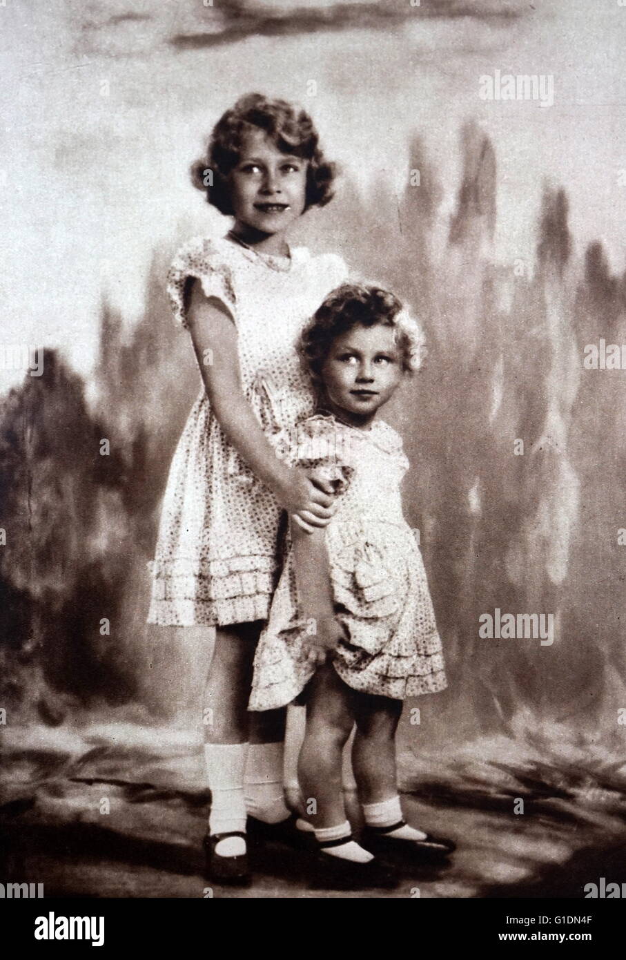 Photograph of young Princess Elizabeth (1926-) and Princess Margaret (1930-2002) posing for a picture. Dated 20th Century Stock Photo