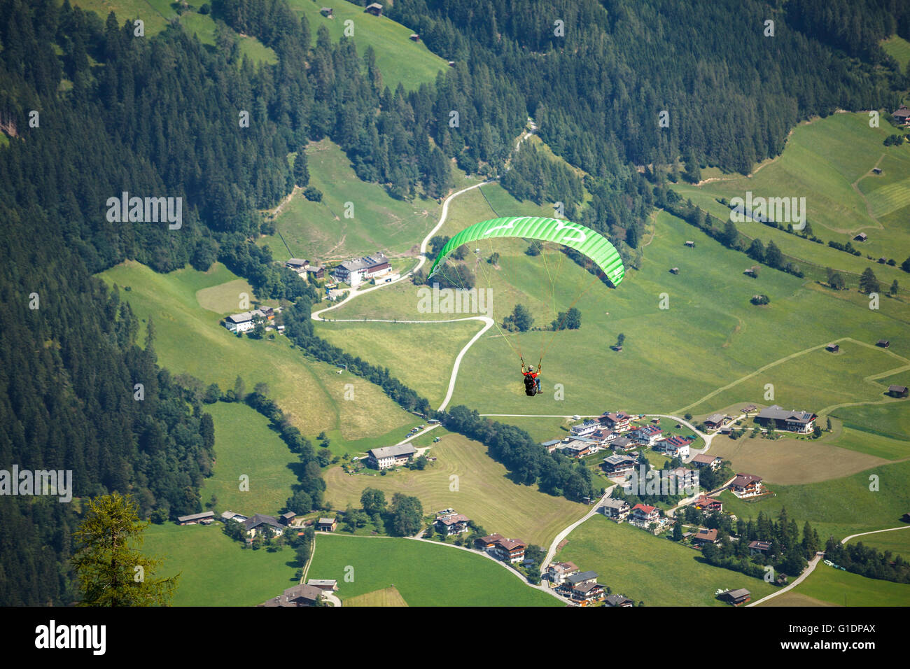 paraglider flying over the Stubai valley over the Neustift im Stubaital, Austria Stock Photo