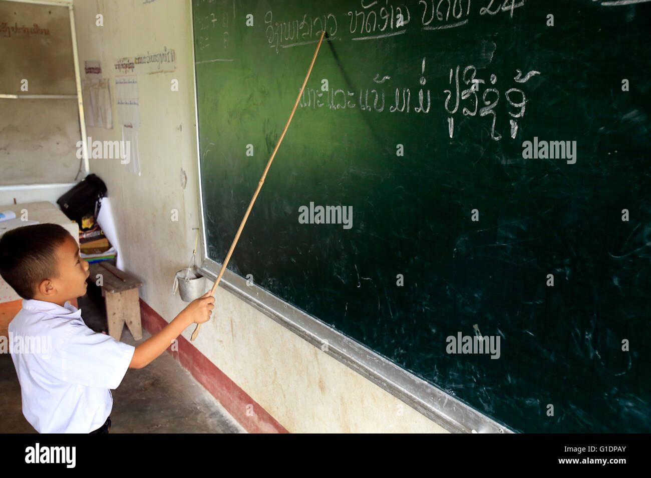 Elementary school.  Classroom. Schoolboy working on blackboard.  Vang Vieng. Laos. Stock Photo