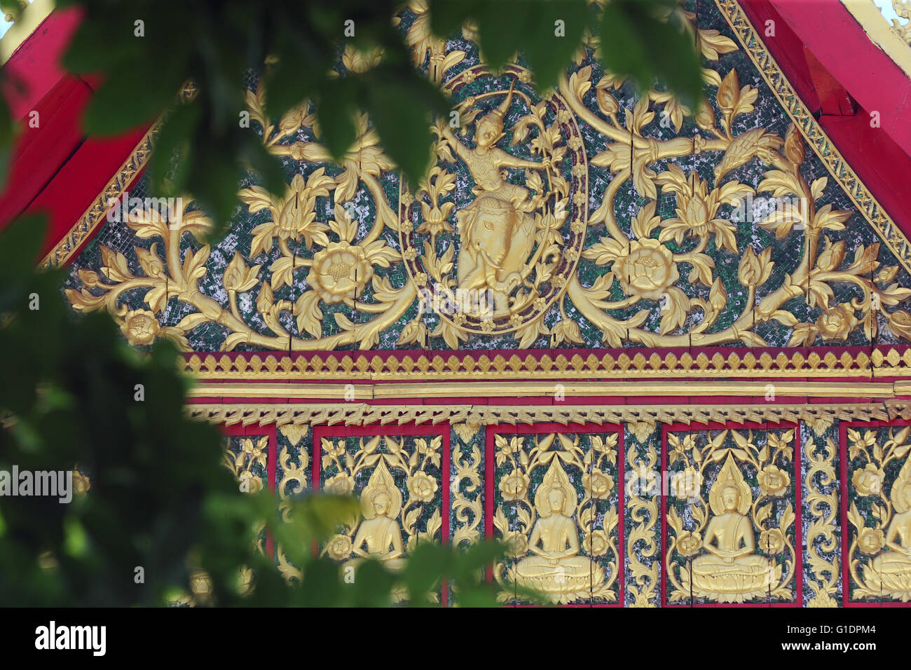 Wat Ong Teu buddhist temple. Gold carving and ornate patterns over the ...