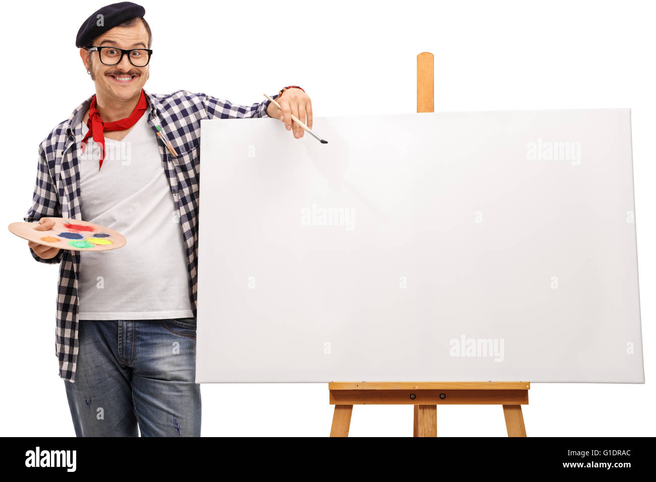 Eccentric artist posing next to a blank canvas on a wooden easel isolated on white background Stock Photo