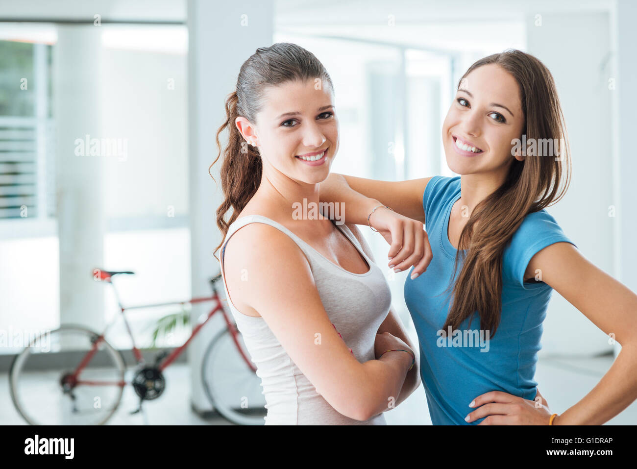 Cute teen girls smiling at camera, adolescence and friendship concept Stock Photo