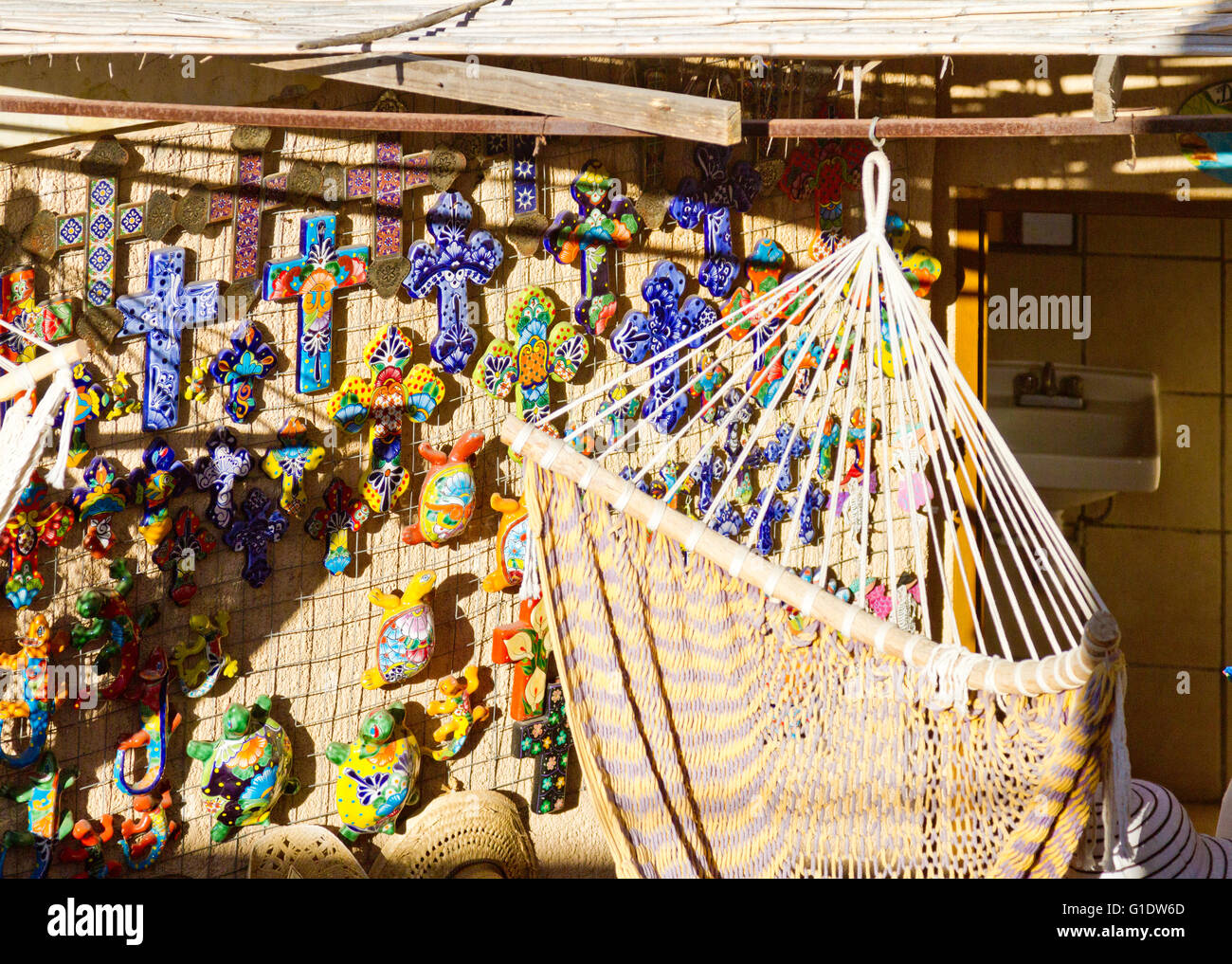 Woven Mexican hammock and wall decorations displayed in a shop in Todos Santos, Baja, Mexico. Stock Photo