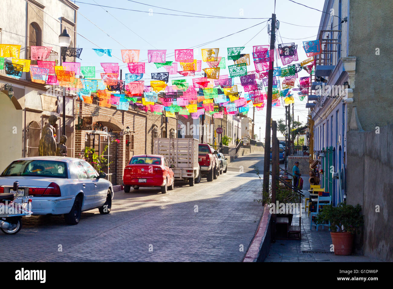 Papel picados (paper flags) decorate a street in Todos Santos, Baja, Mexico. Stock Photo