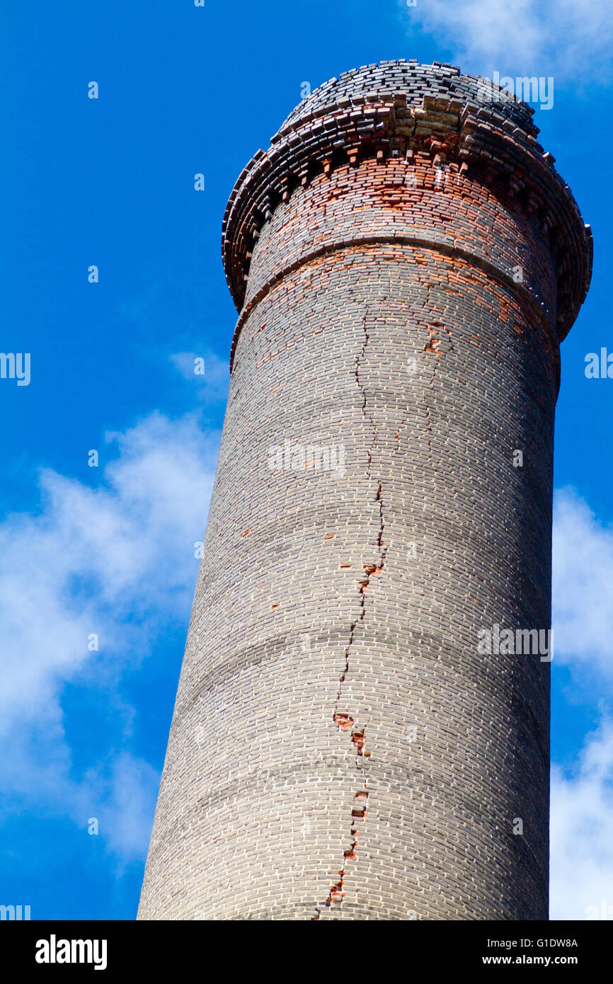 A brick smoke stack designed by Gustave Eiffel at an abandoned silver mine in El Triunfo, Baja Sur, Mexico cracked by hurricane. Stock Photo
