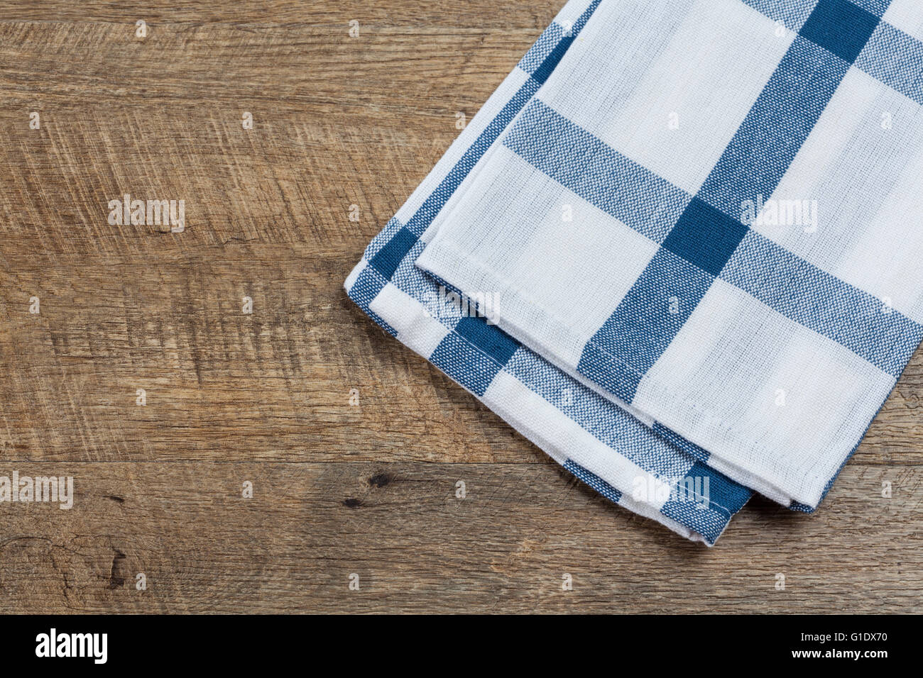 https://c8.alamy.com/comp/G1DX70/checkered-white-blue-kitchen-towel-on-walnut-wood-background-horizontal-G1DX70.jpg