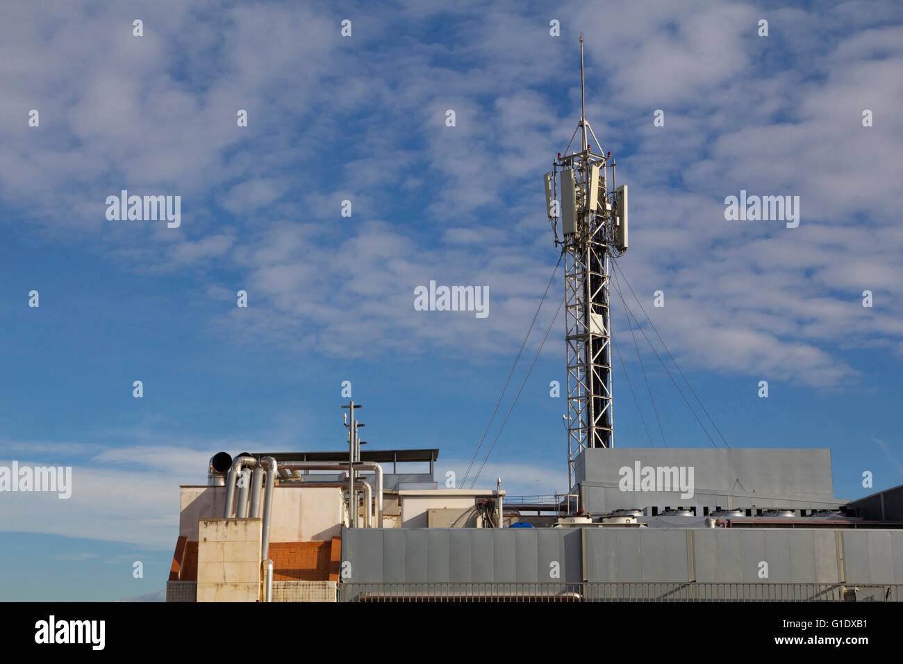 Mobile antenna in a roof top of a building Stock Photo