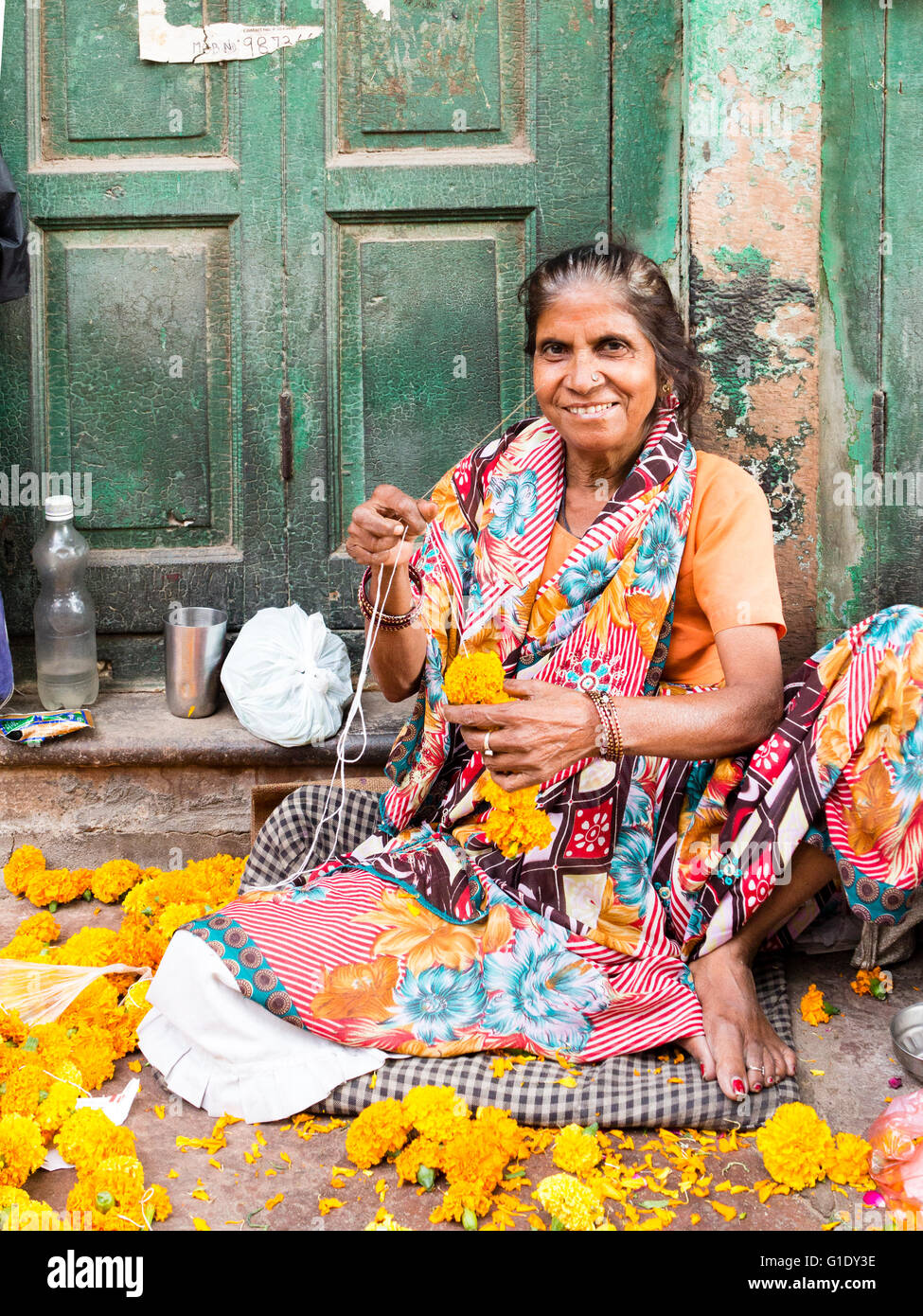 Woman selling flower garlands, Delhi, India Stock Photo
