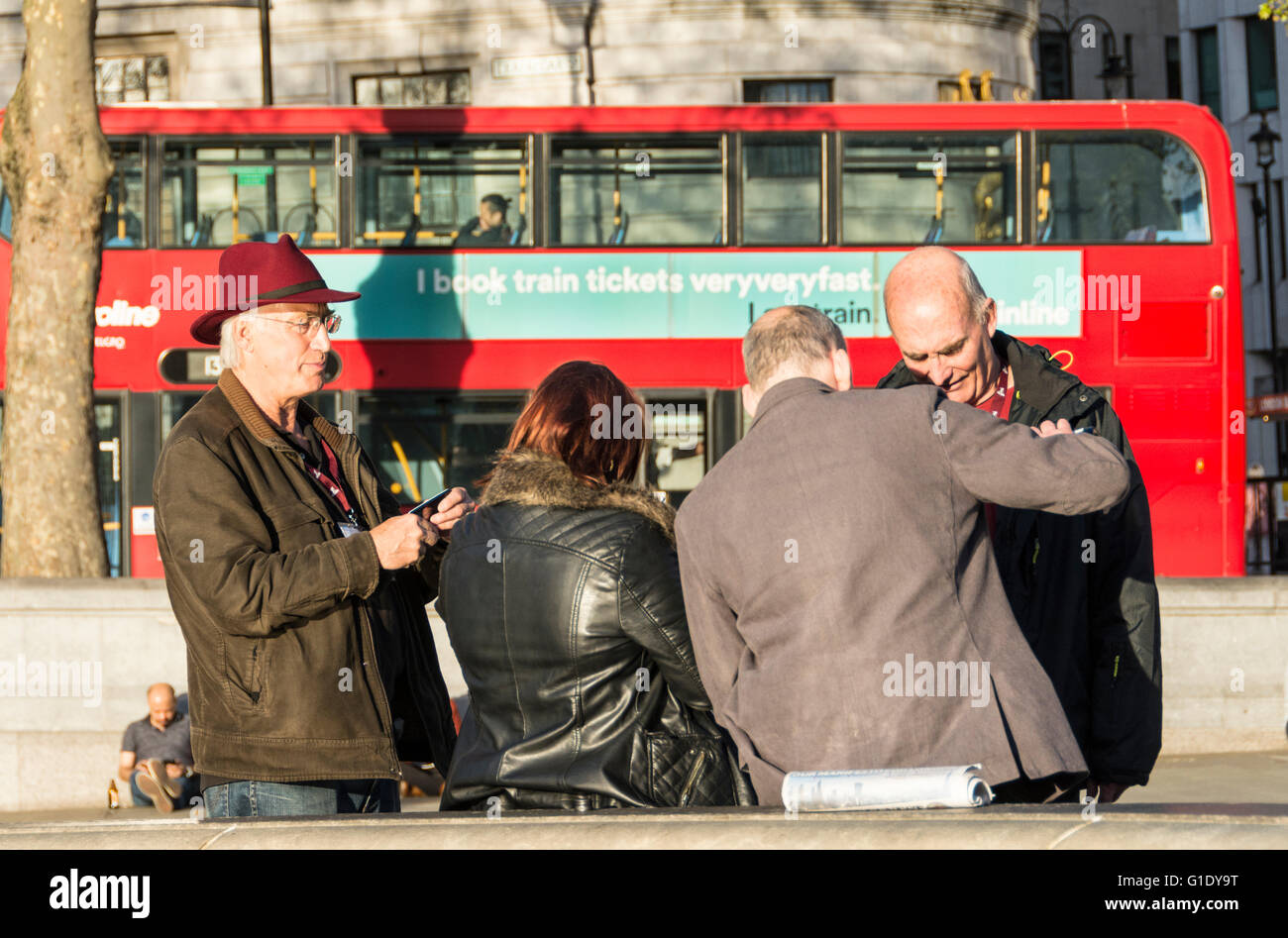Tourists relaxing in Trafalgar Square in London's West End Stock Photo