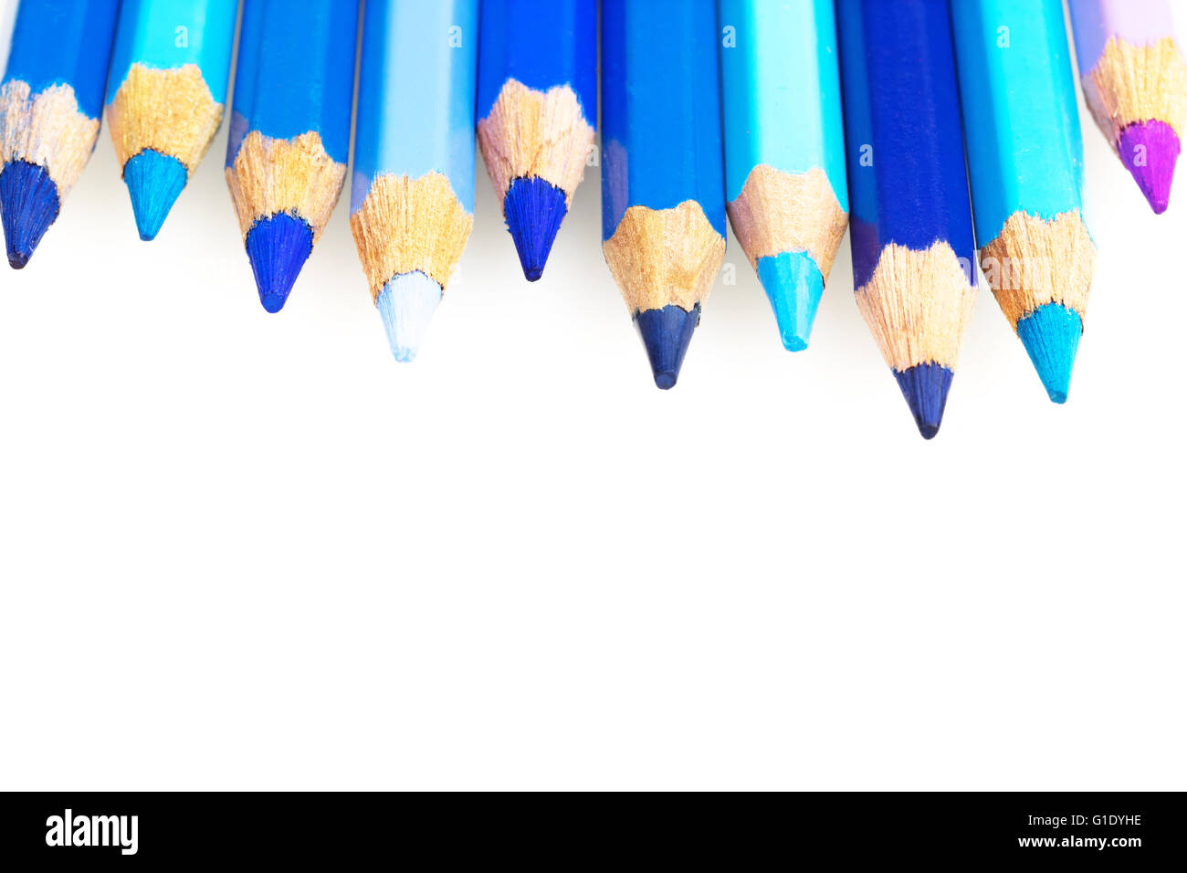 Crayons of different shades of blue color with copy space are located