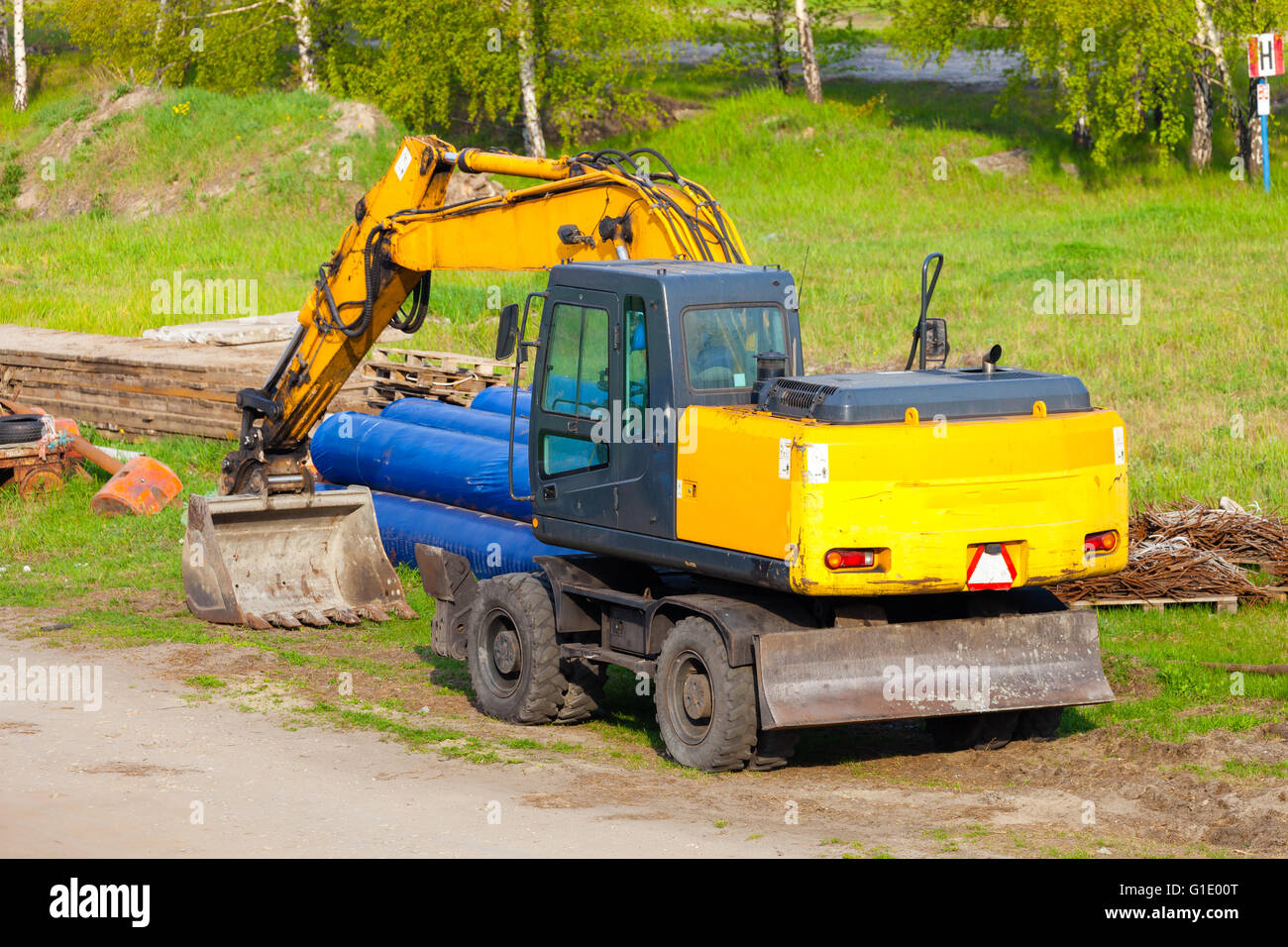 A big yellow excavator at construction site. Stock Photo