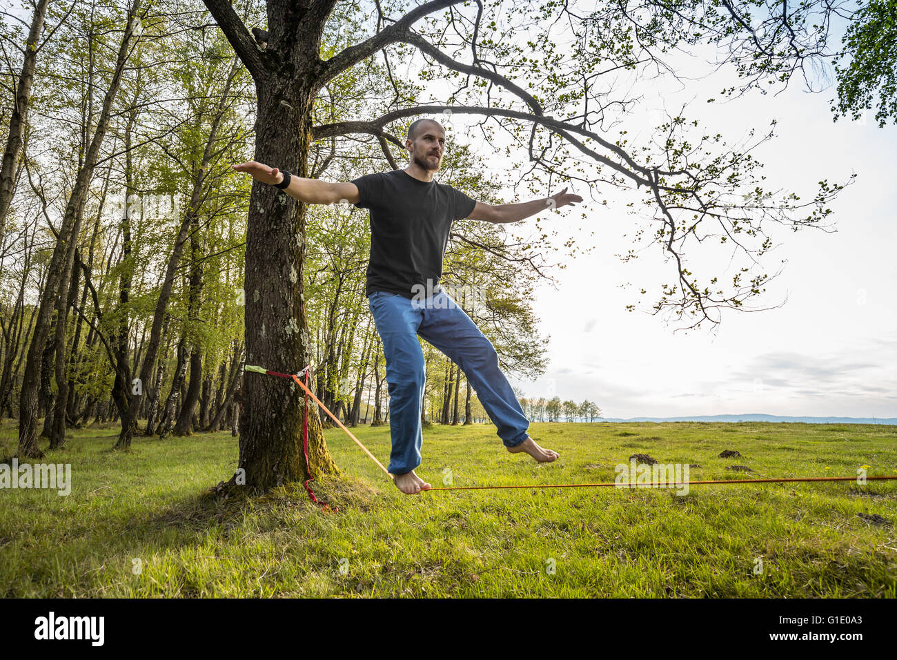 Man slacklining walking and balancing on a rope Stock Photo Alamy