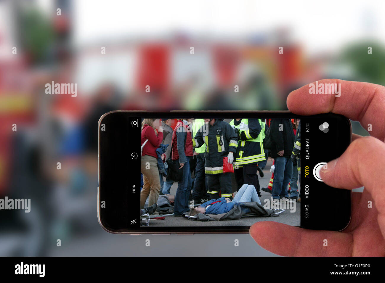 Onlookers take picture with a mobile phone camera, of an accident, symbolic image, photomontage, photo composition, Stock Photo