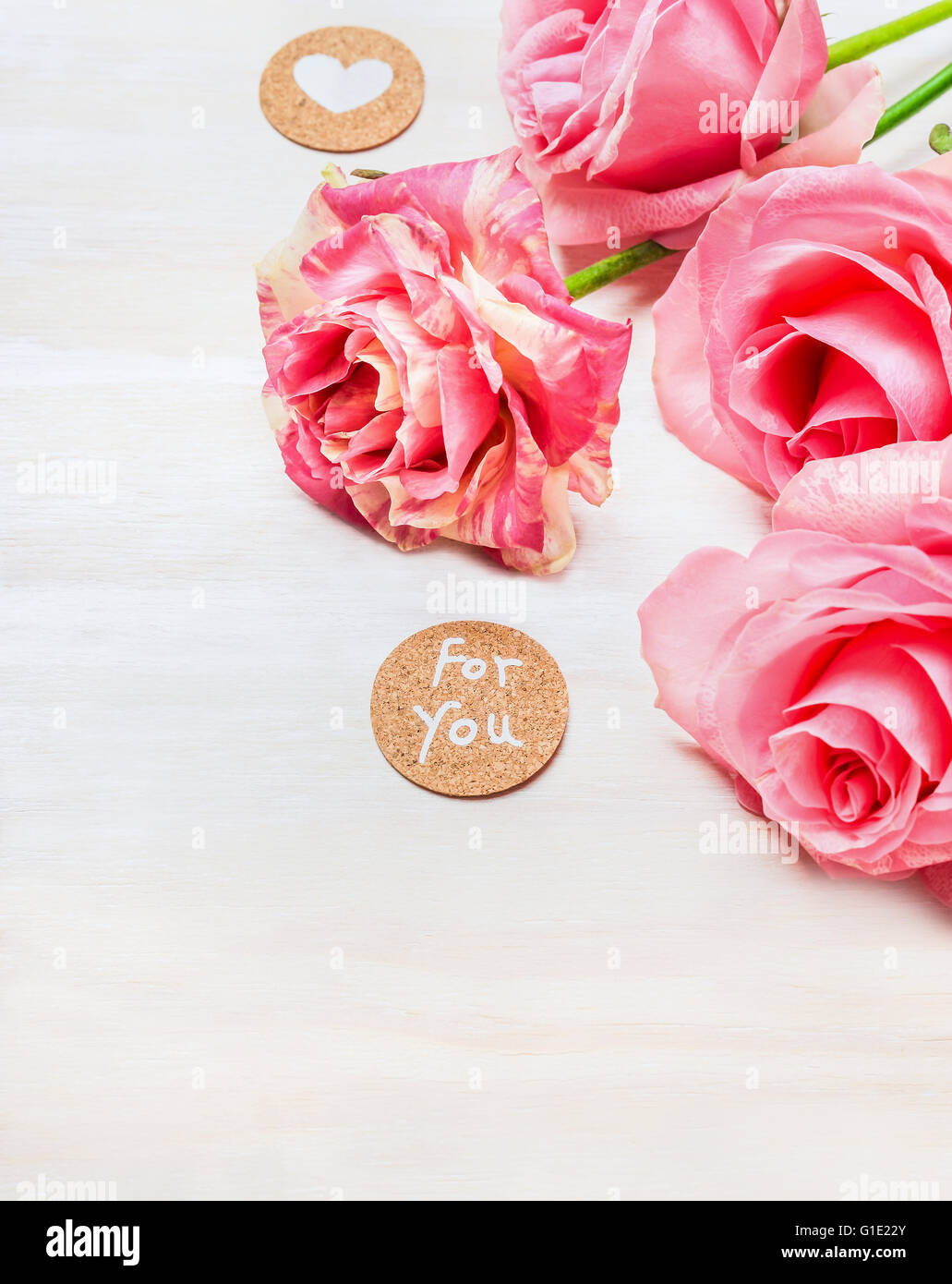 Pink roses with heart and message for you on white wooden background ...