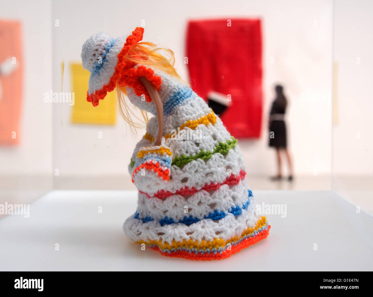 Hamburg, Germany. 13th May, 2016. A knitted toilet paper cover shaped like a doll is seen at an exhibition by artist Andreas Slominski at the Deichtorhallen exhibition hall in Hamburg, Germany, 13 May 2016. Slominksi created an art installation made of more than hundred portable toilets. Photo: Daniel Bockwoldt/dpa/Alamy Live News Stock Photo