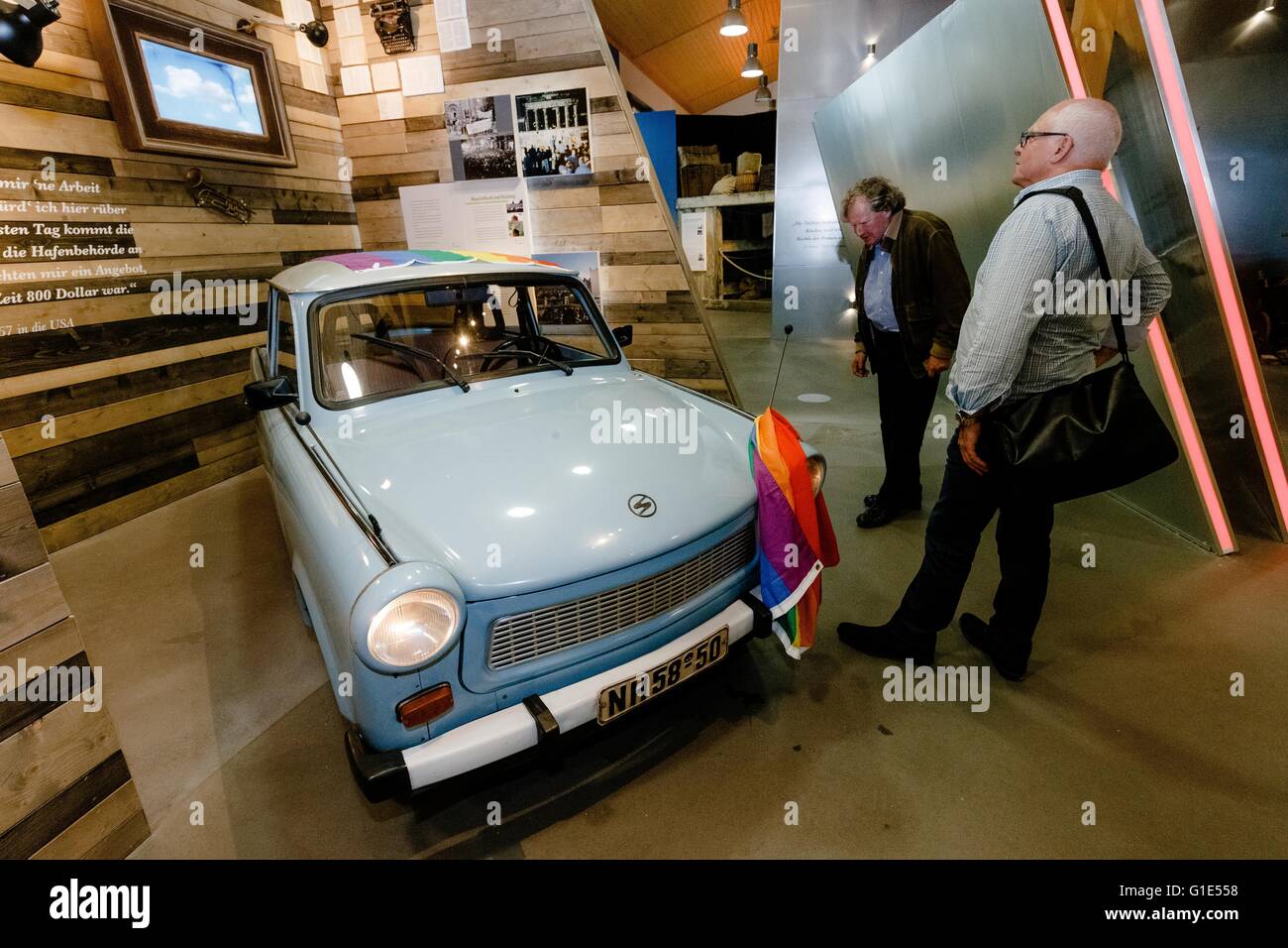 Hamburg, Germany. 13th May, 2016. Visitors looking at a Trabant car produced in the former GDR at the Auswanderermuseum (Emigration Museum) in Hamburg, Germany, 13 May 2016. Today, the museum reopens after a prolonged closure with a newly conceptualised exhibition. PHOTO: MARKUS SCHOLZ/dpa/Alamy Live News Stock Photo