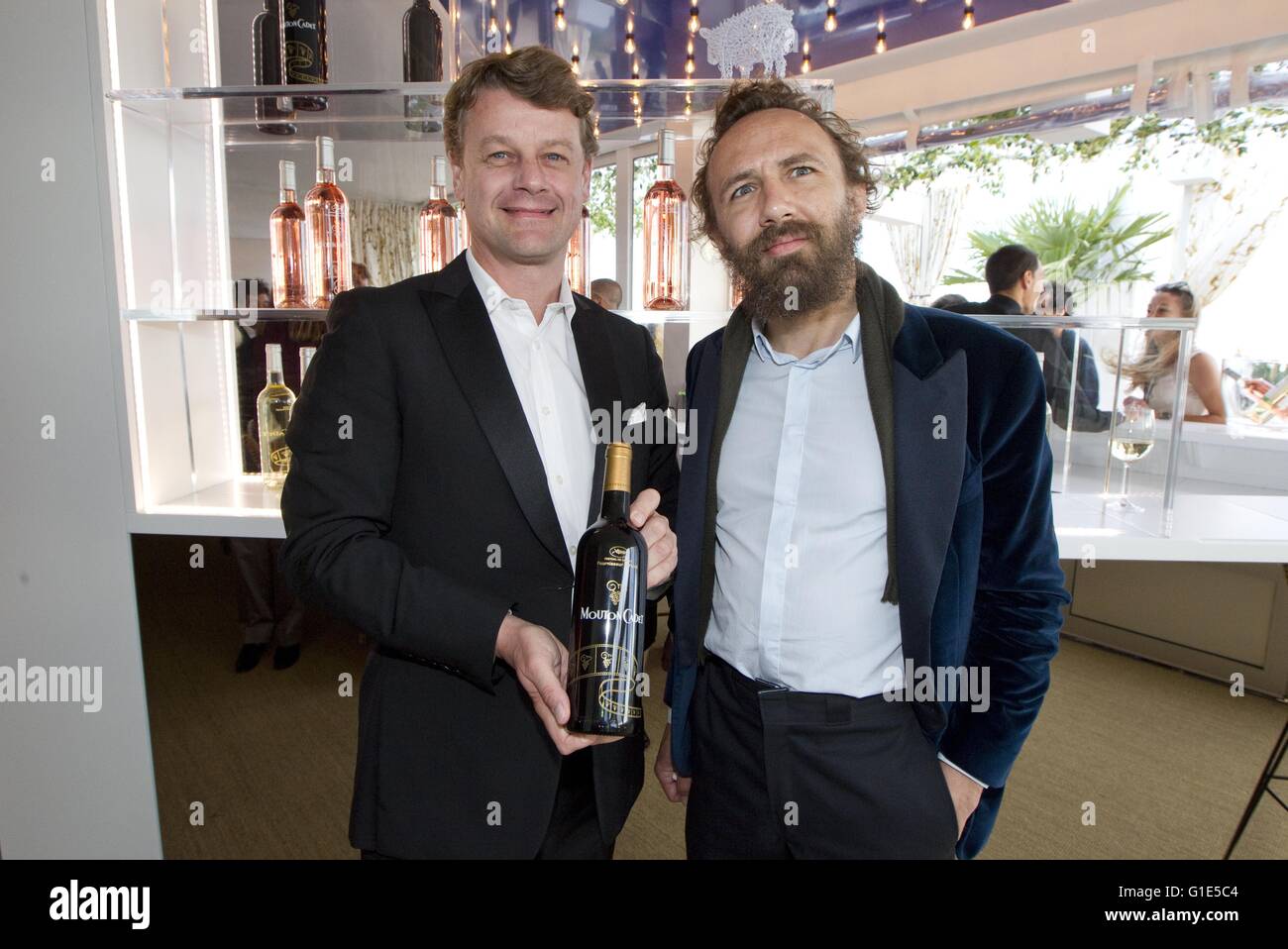 Cannes, France - May 12, 2016: Hugues Lechanoine, CEO of Baron Philippe de Rothschild, S.A. and Artist Mathias Kiss at Mouton Cadet Wine Bar Opening | Verwendung weltweit Stock Photo
