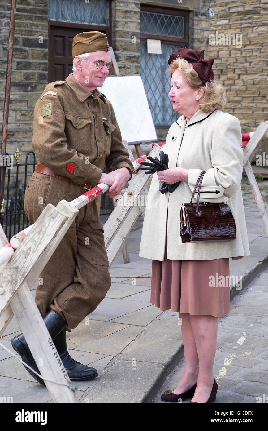 Haworth, Yorkshire, UK. 14th May, 2016. The village of haworth, west yorkshire, is transformed for the annual 1940’s weekend. A member of the home guard is talking to a local re enactor. Credit:  Light-Phase Photography/Alamy Live News Stock Photo