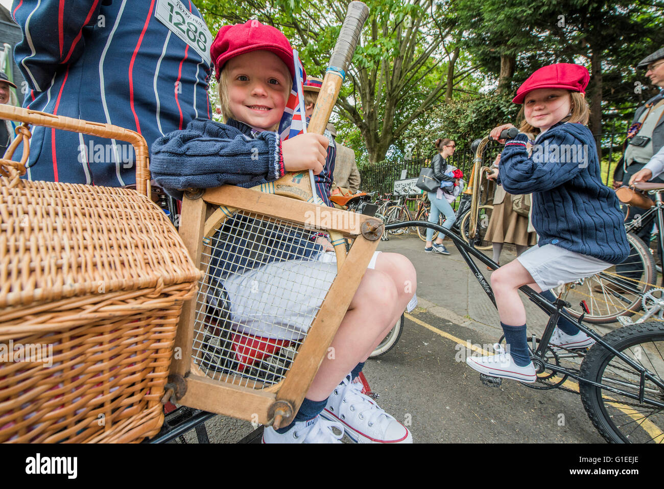 London, UK. 14th May, 2016. A family on a three man bike and tricycle in matching blazers - The Tweed Run, a very British public bicycle ride through London’s streets, with a prerequisite that participants are dressed in their best tweed cycling attire. Now in it's 8th year the ride follows a circular route from Clerkenwell via the Albert Memorial, Buckinham Palace and Westminster. Credit:  Guy Bell/Alamy Live News Stock Photo