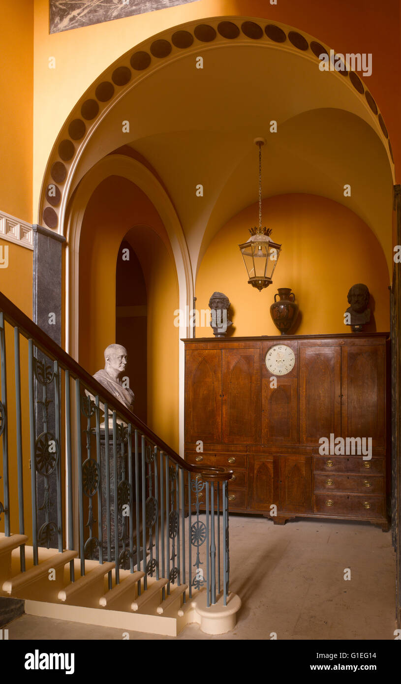 Cairness House, Fraserburgh, Aberdeenshire, Scotland. Partial view of staircase. Large cabinet with busts on top. Stock Photo