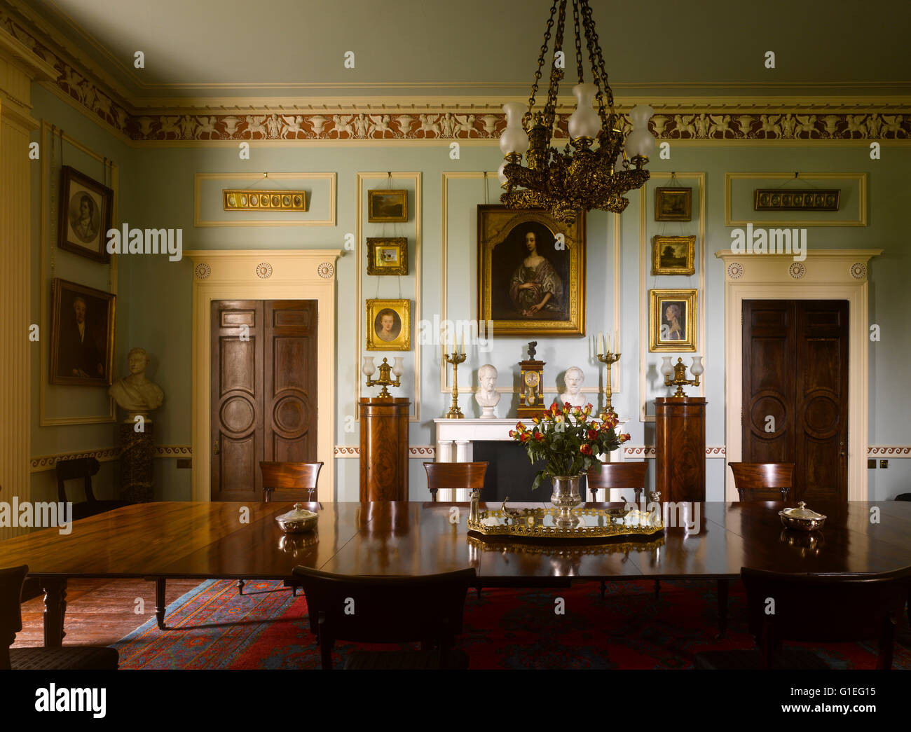 Cairness House, Fraserburgh, Aberdeenshire, Scotland. Long wood table in room with chandelier hanging above. Stock Photo