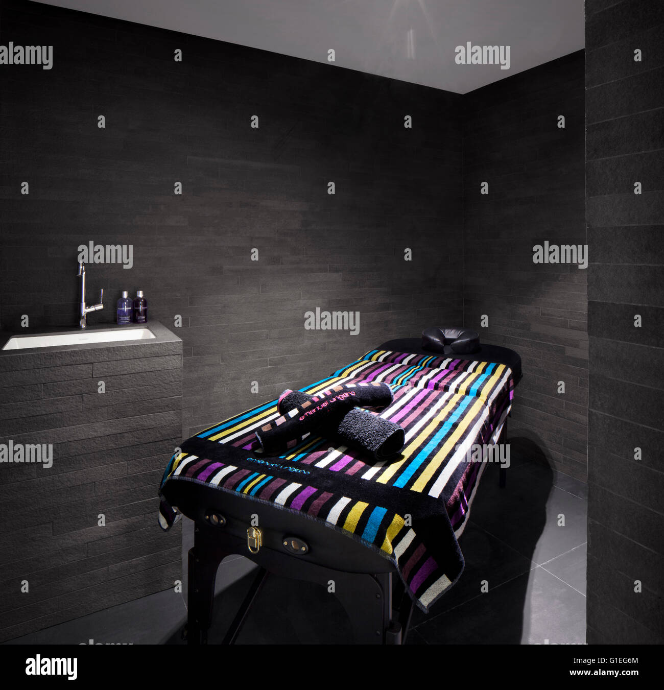 Modern Massage Room with colourful towel and monochrome walls and features. Stock Photo