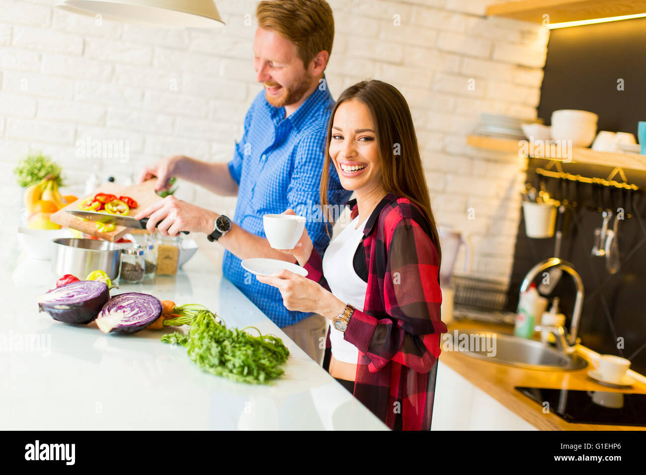 Loving couple preparing healthy food in modern kitchen Stock Photo