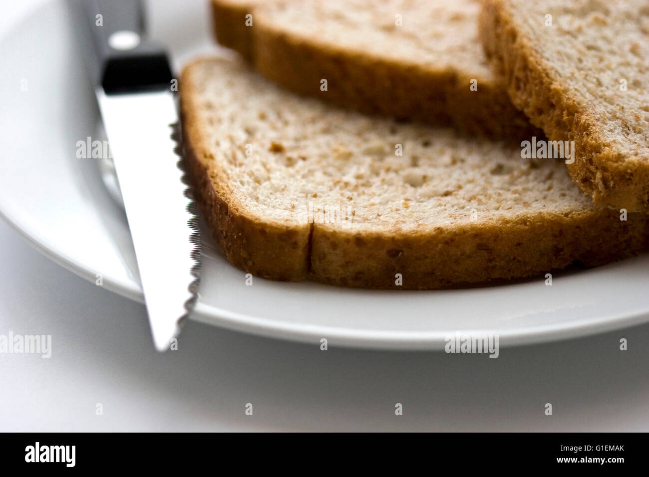 Slices of bread with knife. Stock Photo