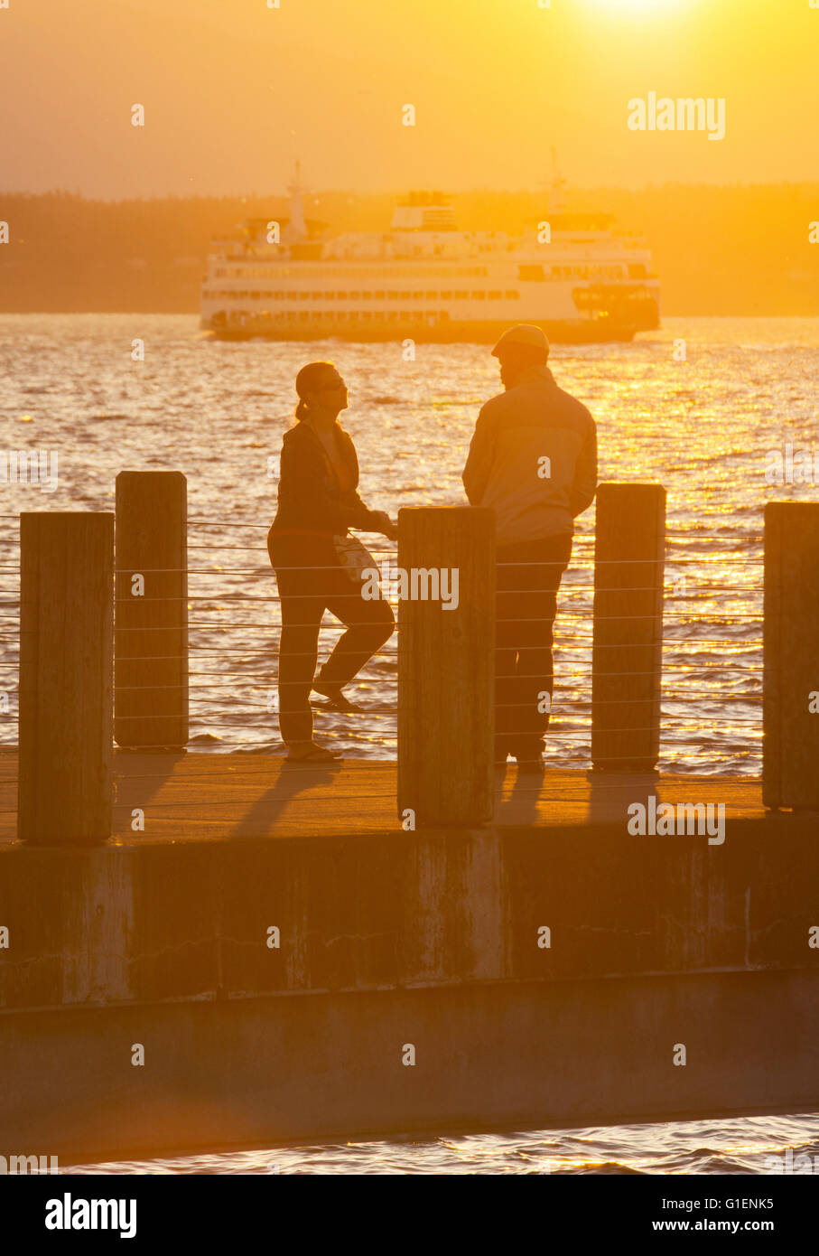 Conversation at sunset, Seattle, Puget Sound, Washington Stock Photo