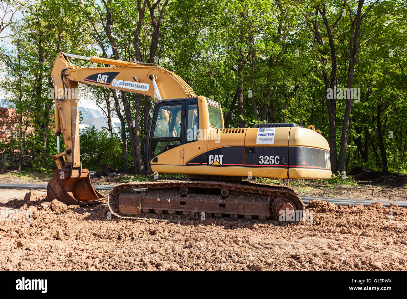 Excavator at construction site in summer sunny day Stock Photo - Alamy