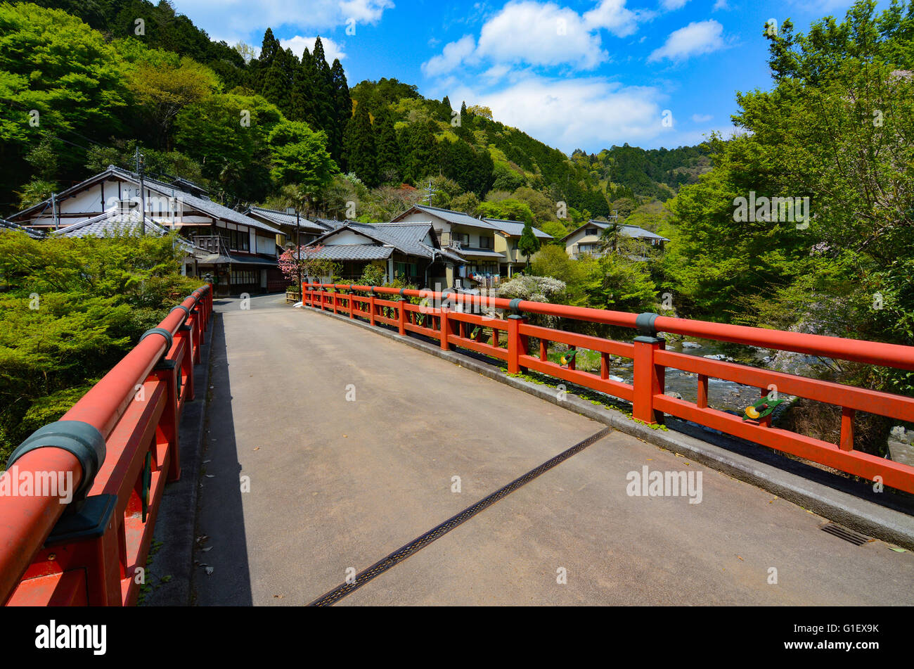 Traditional Japanese red bridge at the entrance to a little village at Kiyotaki Stock Photo