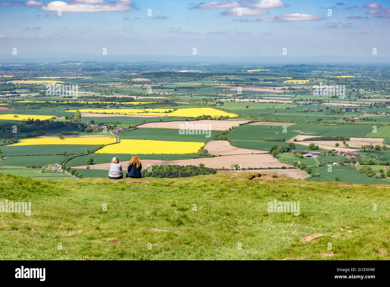 A view of two women sitting at the top of the Wrekin in telford Shropshire Stock Photo