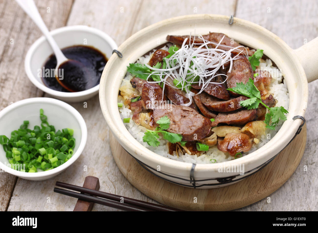 chinese sausage and chicken with rice in clay pot, cantonese food Stock Photo