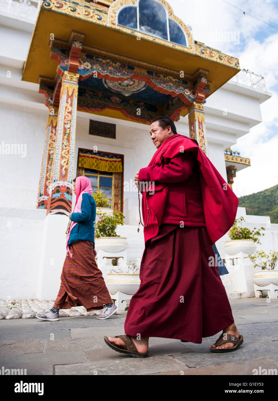 Buddhist monk walking around King Jigme Dorji Wangchuck memorial Thimpu Bhutan Stock Photo